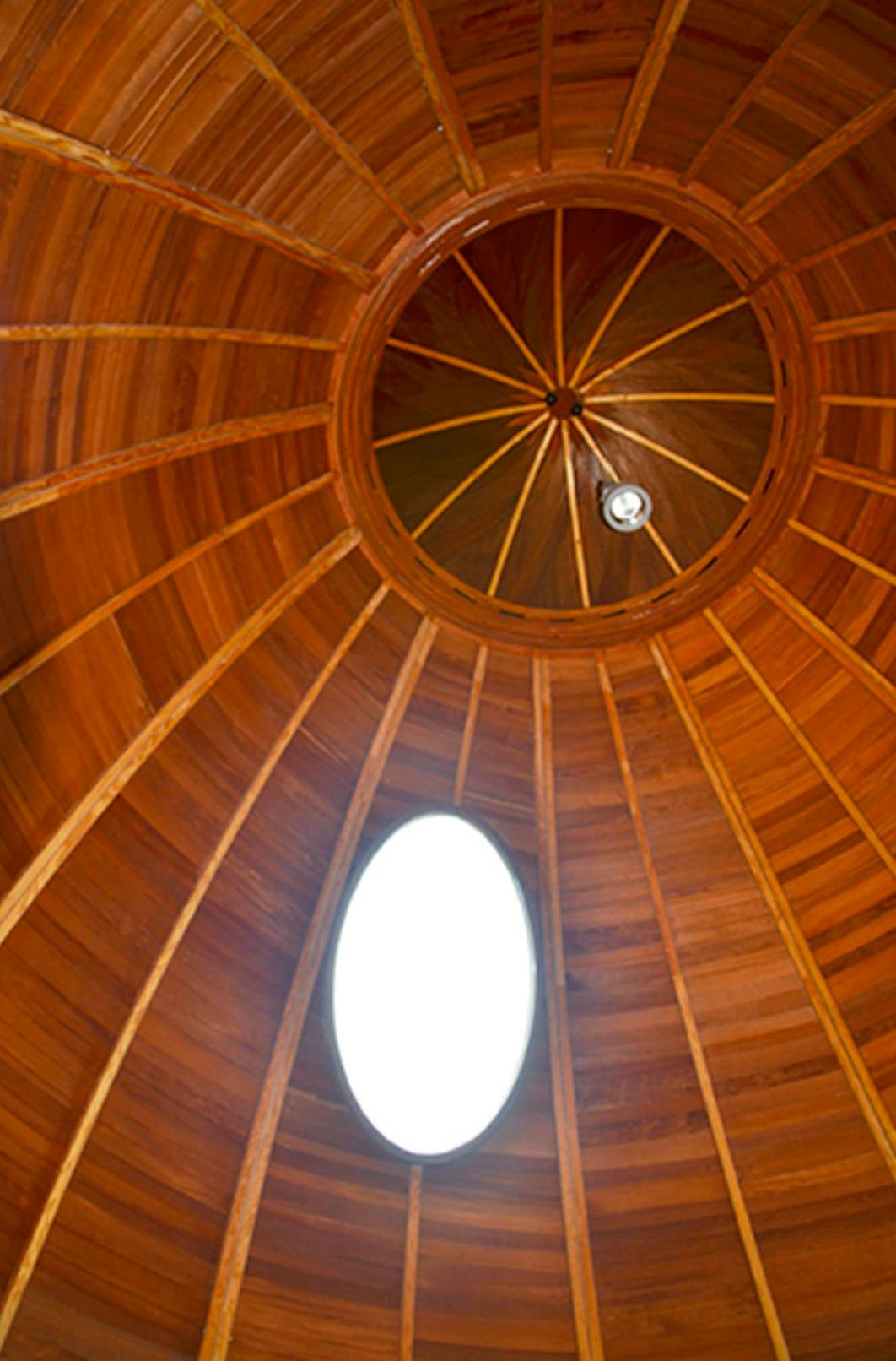 Exbury Egg, by Stephen Turner, 2013. [An oval wooden roof with an oval window cut out from it.]