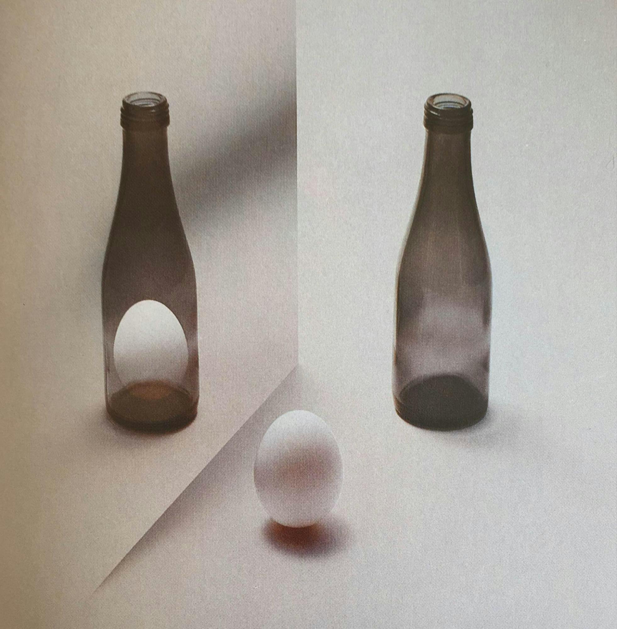 Susumu Endo, 1982. [A photograph of an egg in the foreground and two bottles in the background. One of the bottles has an egg inside of it.]